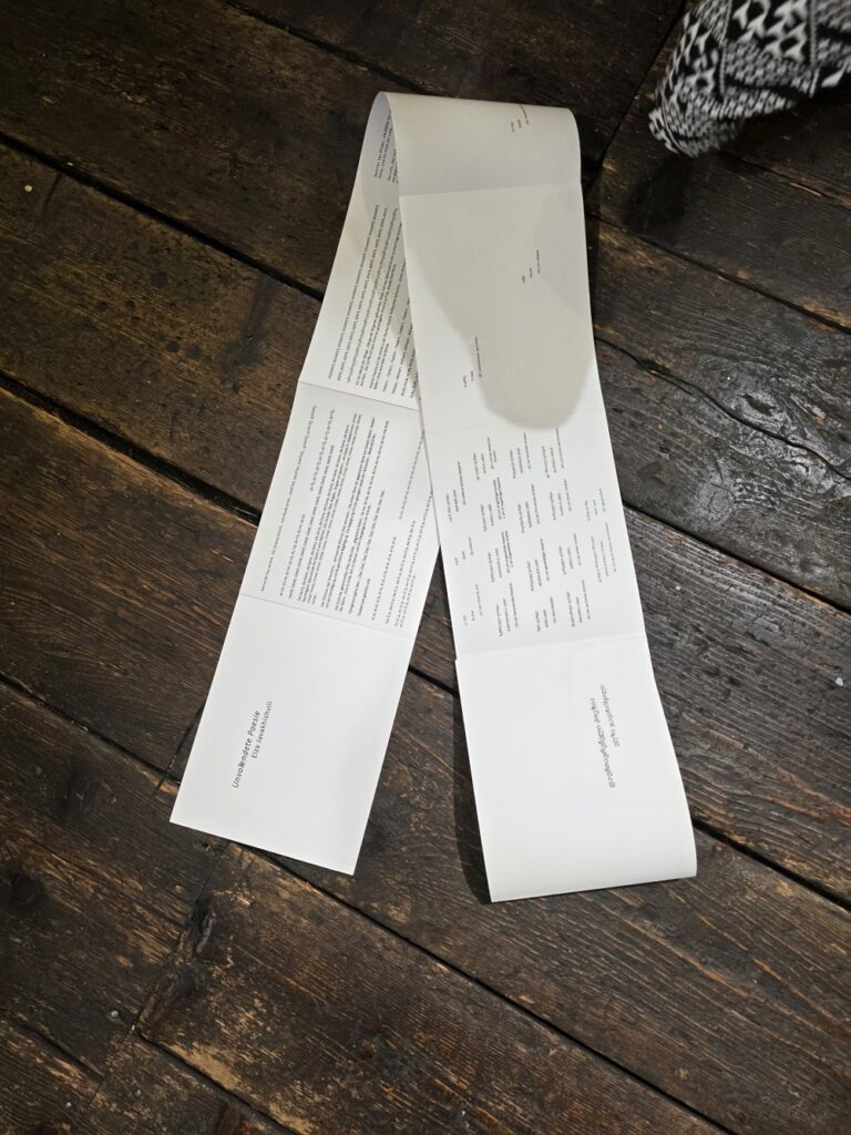 A freshly performed text by Elza Javakhishvili lies on a wooden floor.